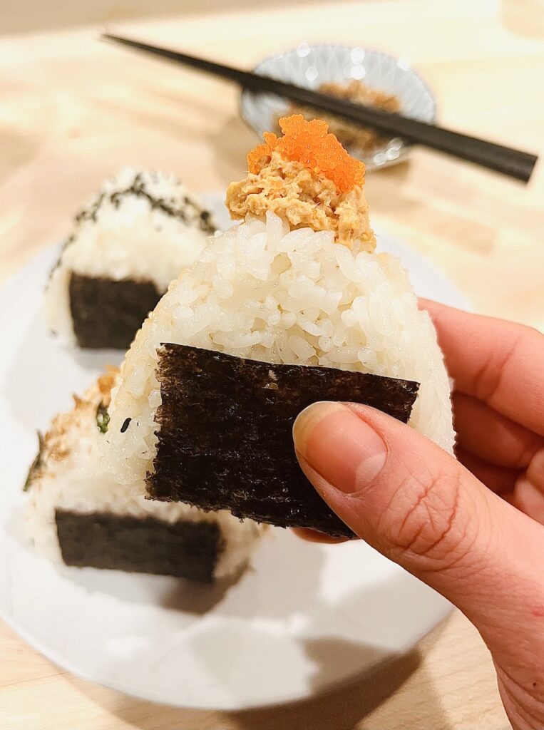 Close up shot of onigiri with spicy salmon filling