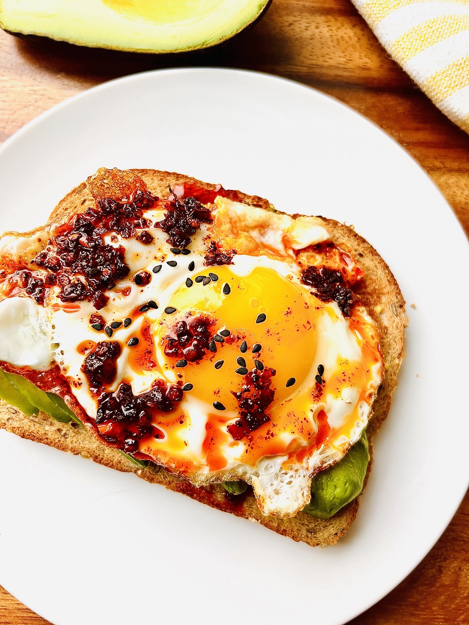 Avocado toast with sunny side up egg and chili oil