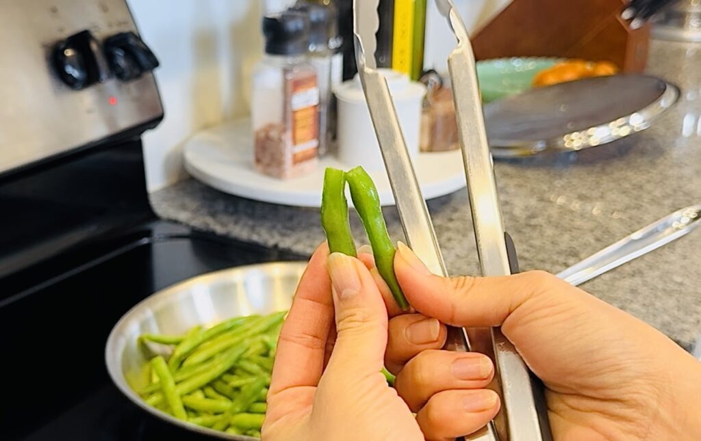 bending the green bean and it snapping, crispy