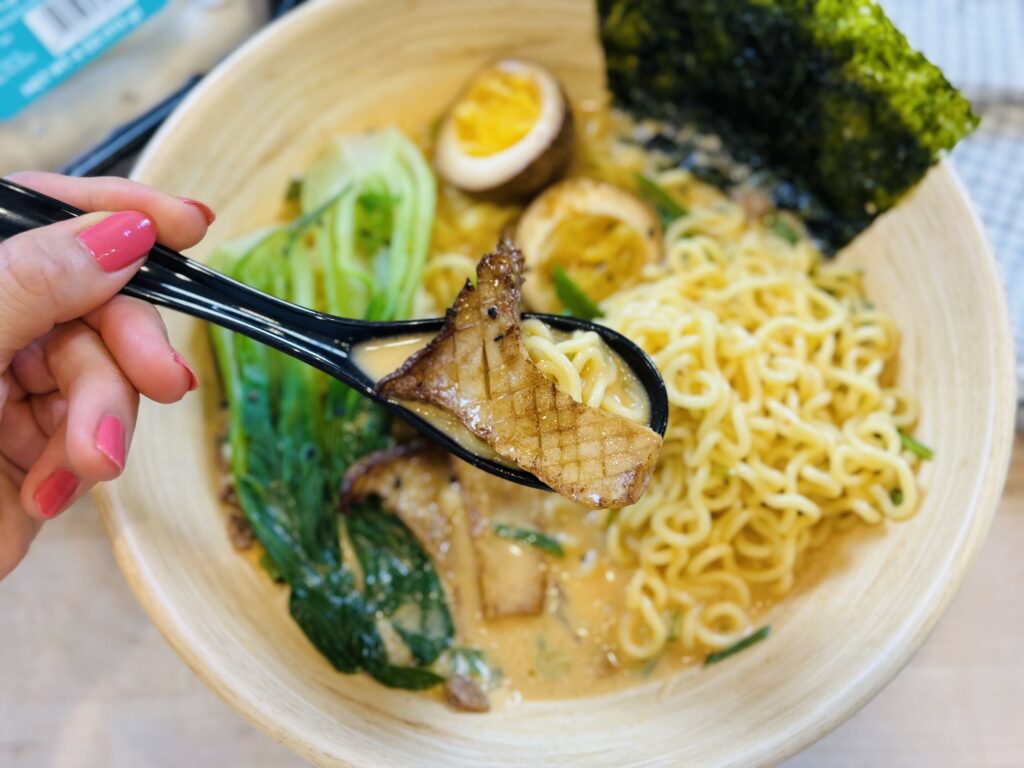 fancy ramen ready to eat with spoon of noodles and mushroom