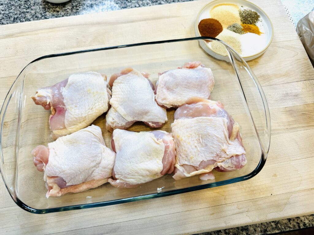 Raw chicken with bones, and plate with seasonings
