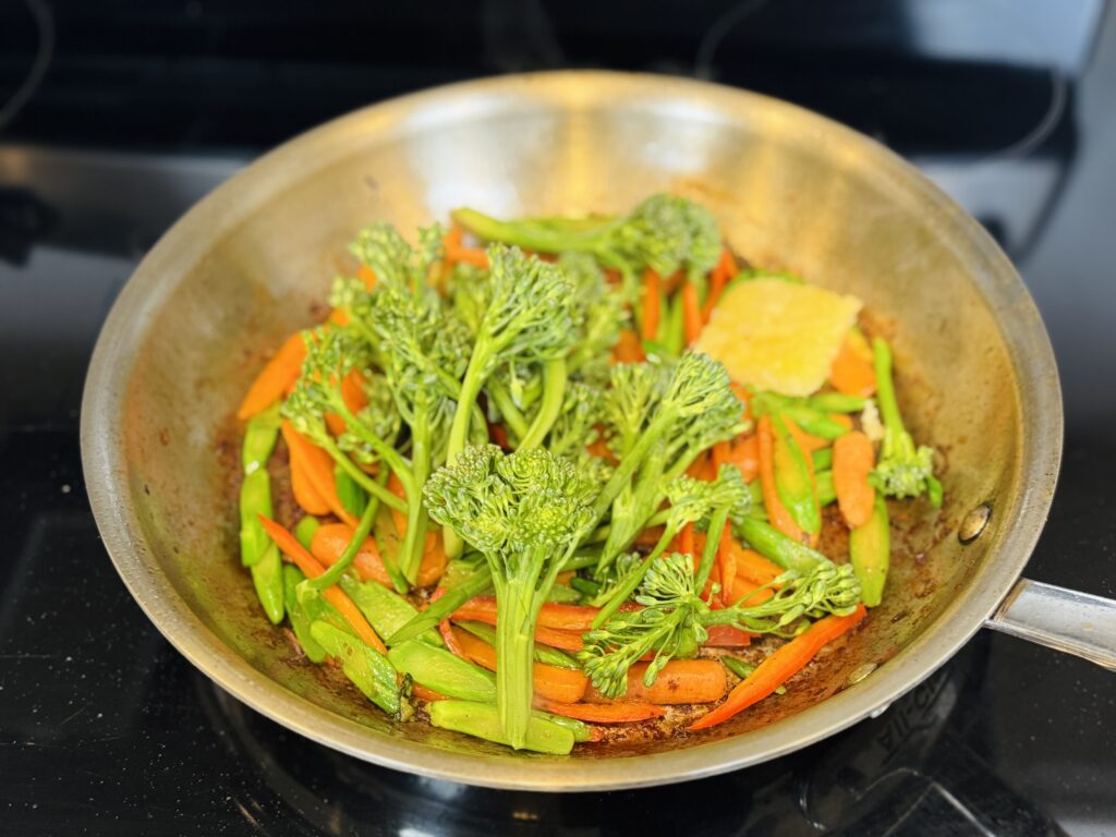 Sauté the carrots, broccoli, and bell pepper on the pan
