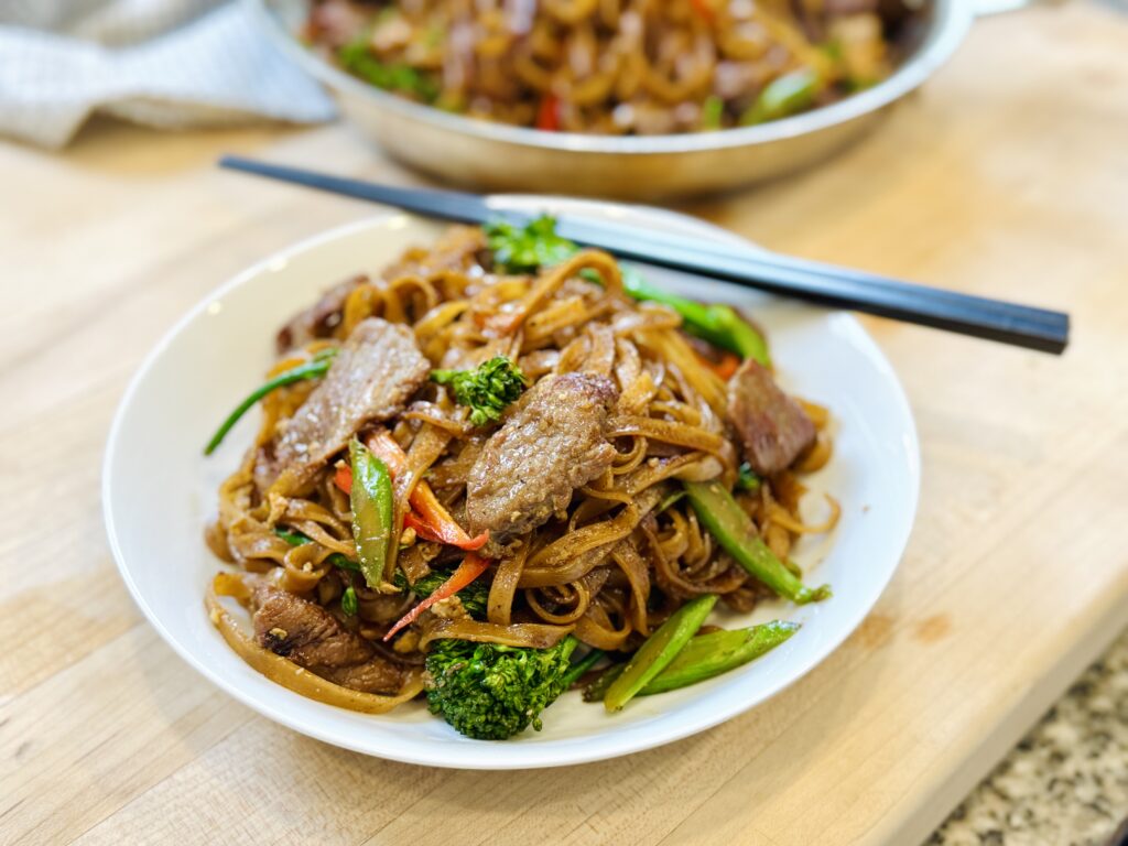Thai Stir-Fried Noodles in small plate with chopsticks on the side