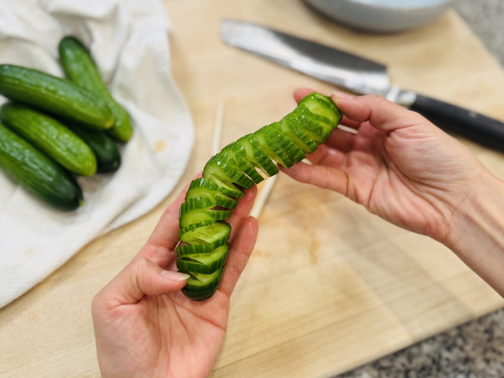 Baby cucumber sliced into spiral shape like an accordian