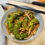 Spiral Baby Cucumber Kimchi — ridged baby cucumber pieces tossed in gochugaru, garnished with sesame seeds