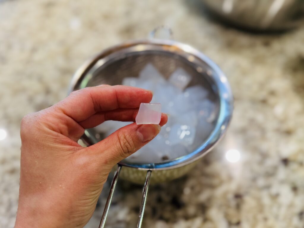 Close-up of coconut jelly cubes — translucent white jelly pieces used in hwachae Korean fruit punch