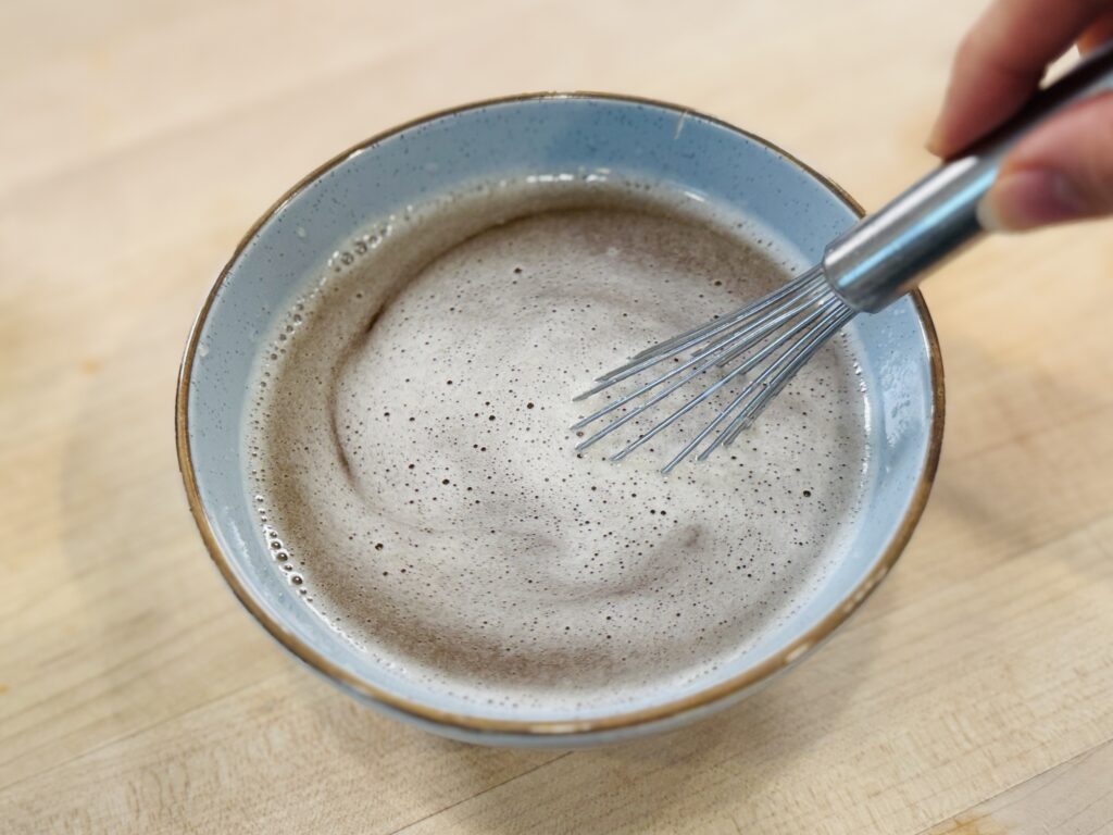 Whisk stirring apple juice and gelatin together in a bowl until smooth and lump-free